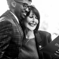 Gentleman at dedication event sharing hug with President Mantella